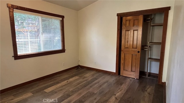 spare room with dark hardwood / wood-style flooring