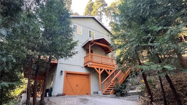 24861 Finhaut Dr, Crestline, CA 92325 - view of front facade with stairs, a garage, and asphalt driveway