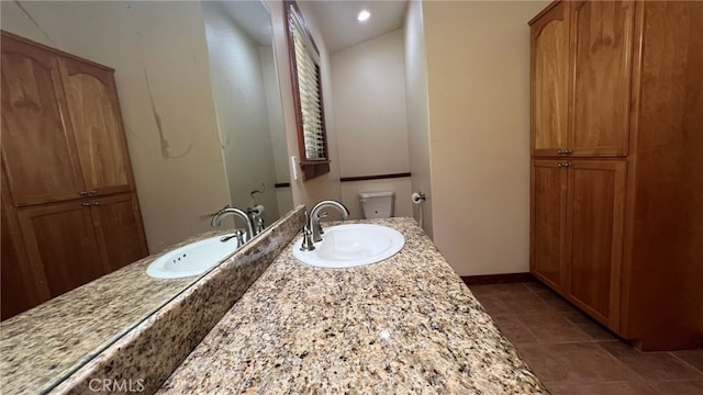 bathroom with vanity, toilet, and tile patterned flooring