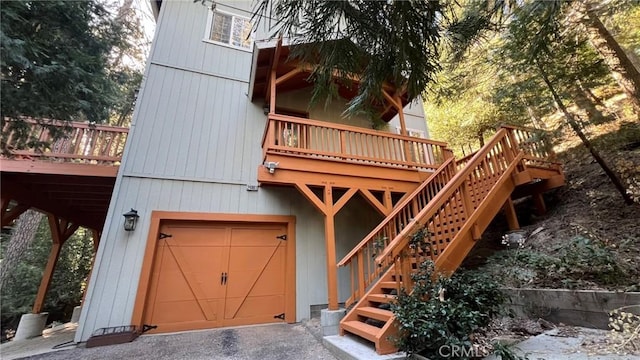 24861 Finhaut Dr, Crestline, CA 92325 - view of front of property with stairway, an attached garage, and a wooden deck