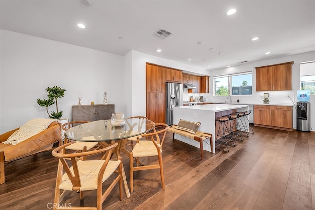 dining area featuring sink and dark hardwood / wood-style flooring