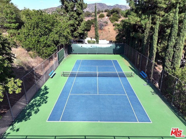 view of tennis court with a mountain view