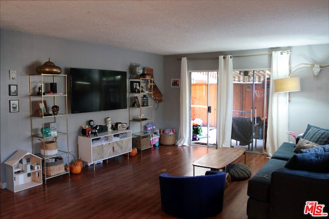 living room with dark hardwood / wood-style floors and a textured ceiling