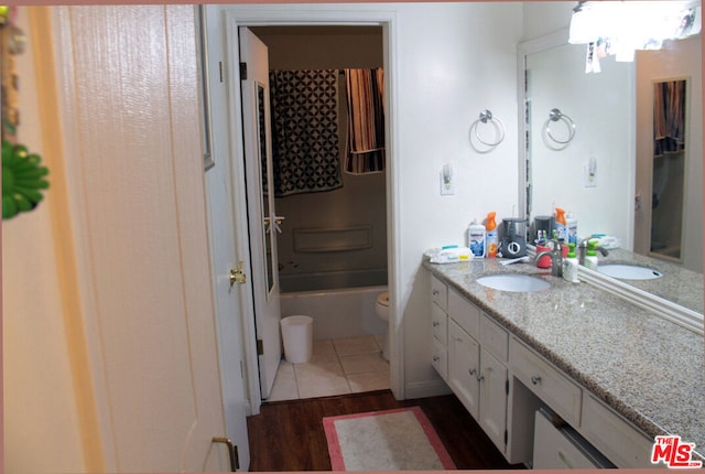 full bathroom featuring vanity, toilet, wood-type flooring, and shower / washtub combination