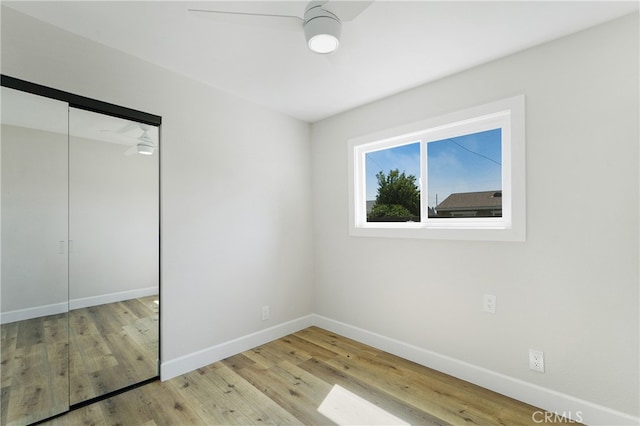 unfurnished bedroom featuring a closet and light wood-type flooring