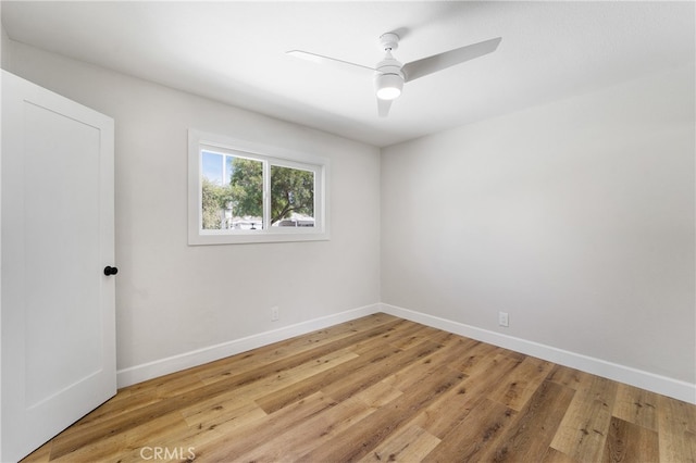 spare room featuring light wood-type flooring and ceiling fan