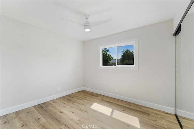 empty room featuring light wood-type flooring and ceiling fan