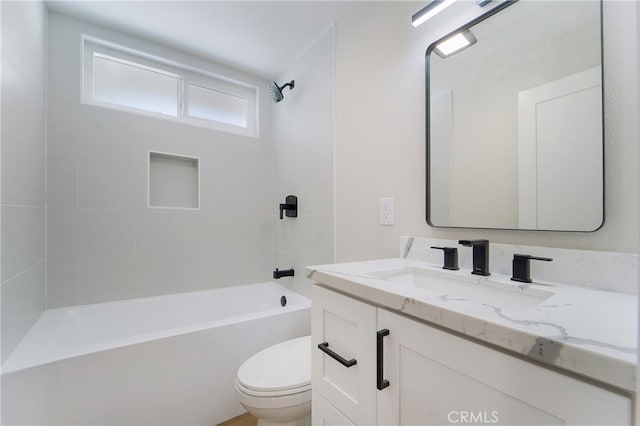 full bathroom with vanity, toilet, and tiled shower / bath combo