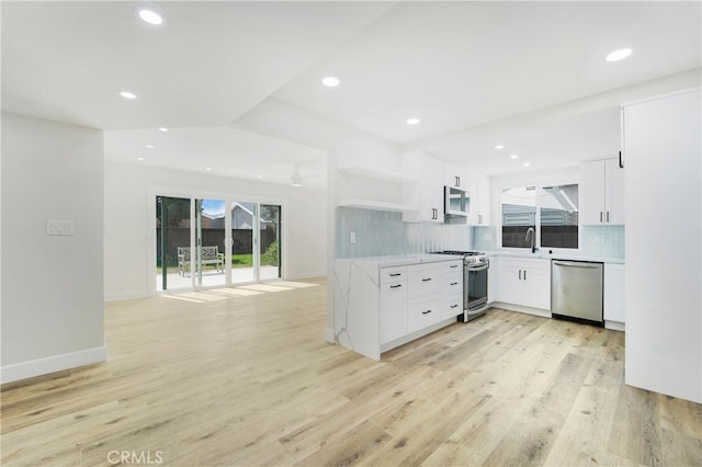 kitchen featuring white cabinets, a healthy amount of sunlight, and stainless steel appliances