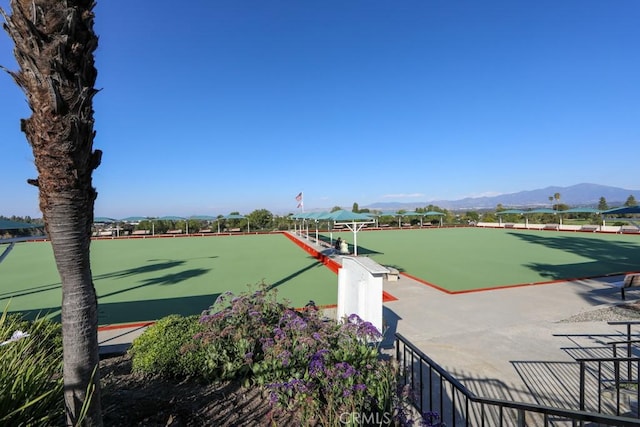 view of home's community featuring fence and a mountain view