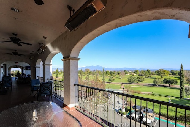 balcony featuring ceiling fan and a mountain view