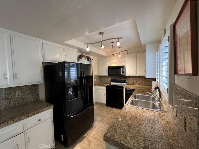 kitchen featuring black appliances, sink, decorative backsplash, a tray ceiling, and white cabinetry