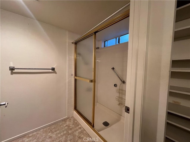 bathroom featuring an enclosed shower and baseboards