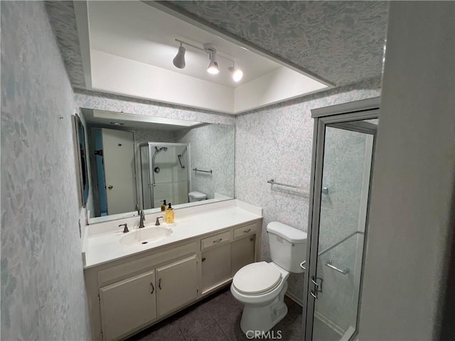 full bathroom featuring toilet, a stall shower, vanity, tile patterned flooring, and wallpapered walls