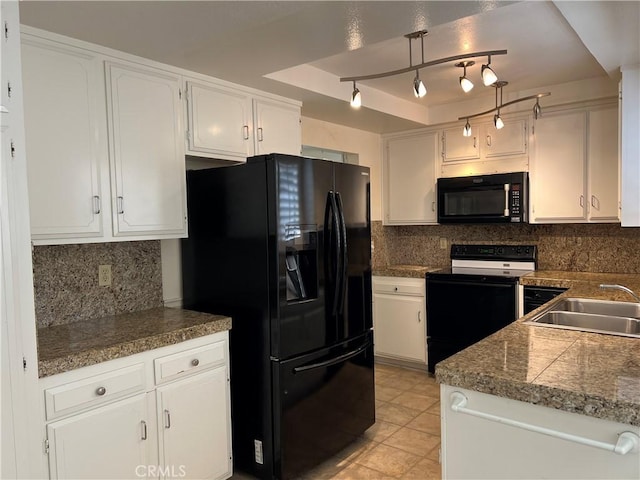 kitchen featuring a sink, white cabinets, black appliances, tasteful backsplash, and a raised ceiling