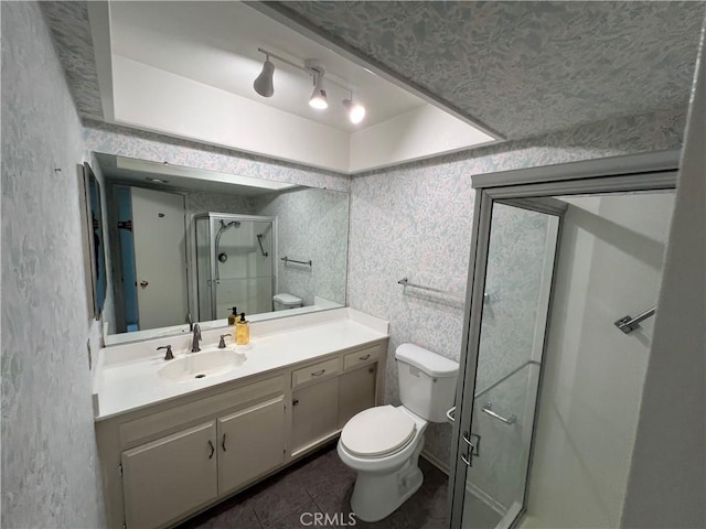 full bathroom with toilet, wallpapered walls, a stall shower, and vanity