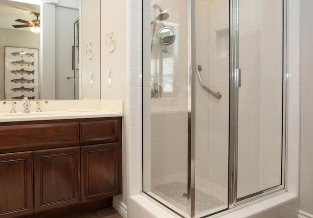 bathroom featuring vanity, ceiling fan, and an enclosed shower