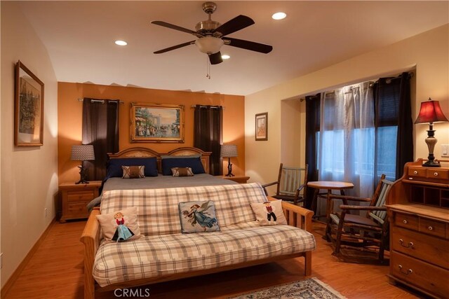 bedroom with ceiling fan and light hardwood / wood-style floors