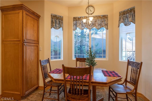 dining area with an inviting chandelier