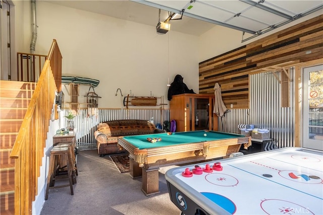 rec room with carpet flooring, wood walls, and pool table