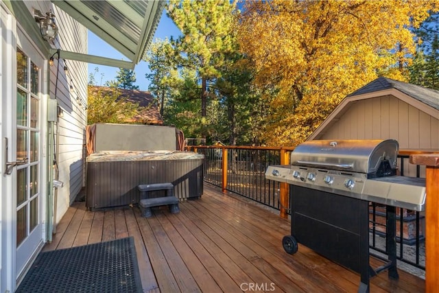 wooden terrace featuring a hot tub