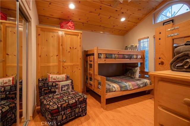 bedroom featuring lofted ceiling, light hardwood / wood-style floors, and wood ceiling