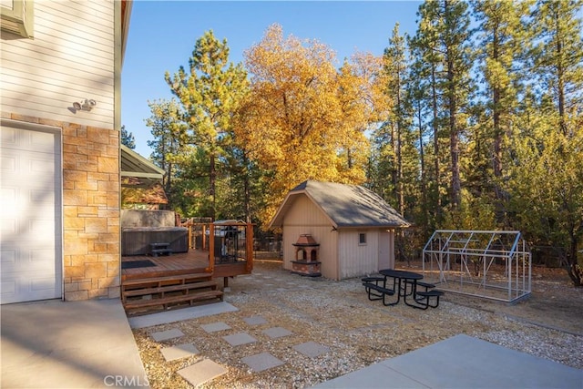 view of patio / terrace featuring a storage shed and a wooden deck