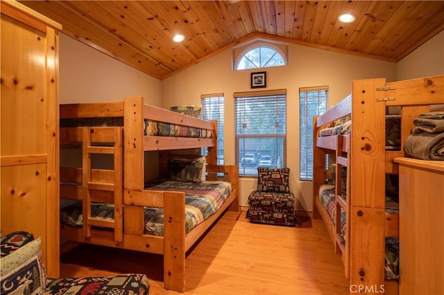 bedroom featuring light hardwood / wood-style floors, lofted ceiling, and wood ceiling