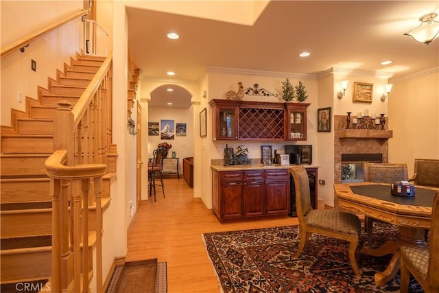 bar with crown molding and light hardwood / wood-style floors