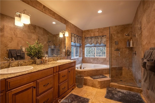 bathroom with vanity, tile patterned floors, vaulted ceiling, tile walls, and independent shower and bath