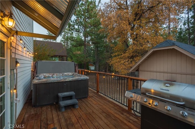 deck with area for grilling and a hot tub