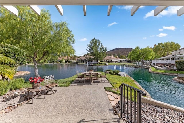 view of patio / terrace with a water and mountain view