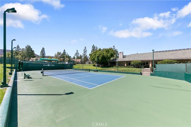 view of sport court featuring basketball hoop