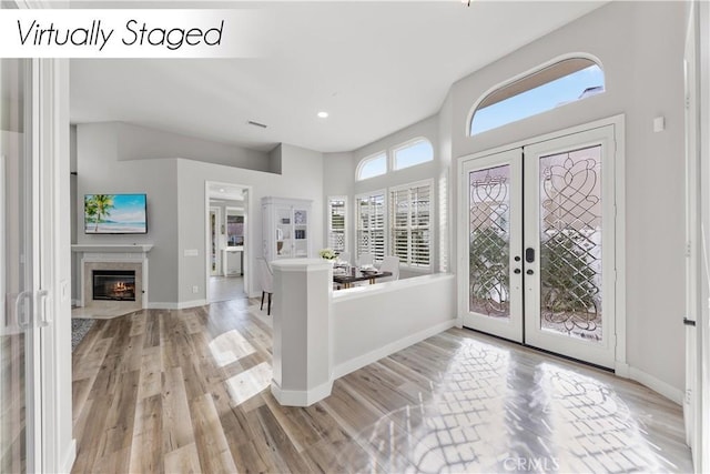 foyer with french doors and light wood-type flooring