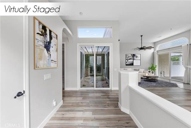 foyer with ceiling fan and light wood-type flooring