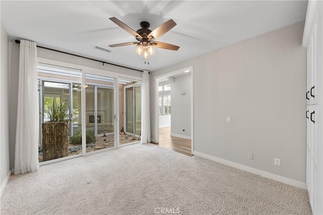 carpeted empty room featuring ceiling fan