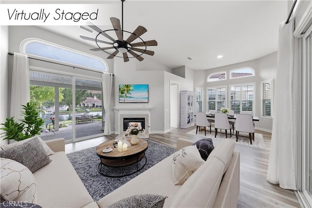 living room featuring ceiling fan and light hardwood / wood-style flooring