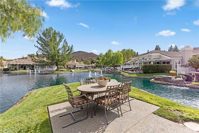 view of patio / terrace with a water and mountain view