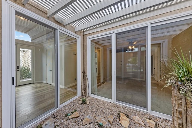 property entrance with a pergola