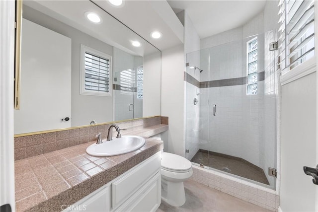 bathroom with vanity, toilet, and walk in shower