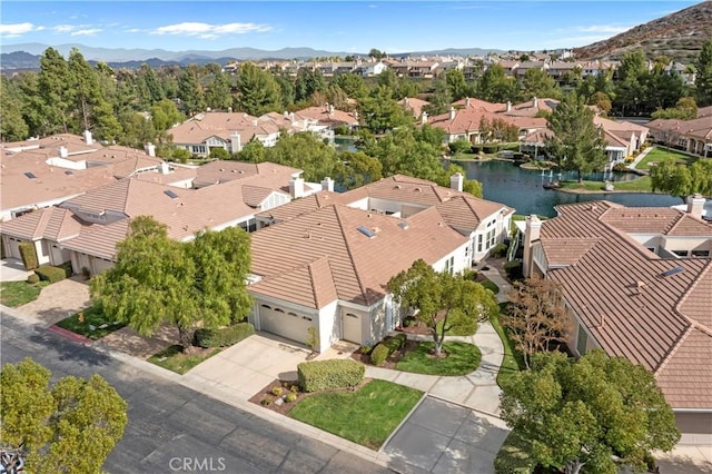 birds eye view of property featuring a water and mountain view