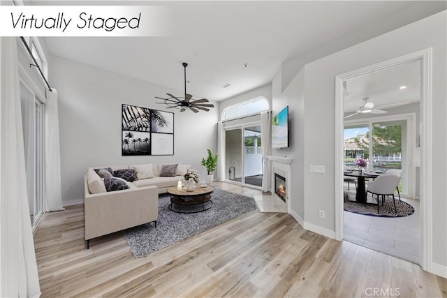 living room with ceiling fan and light hardwood / wood-style floors