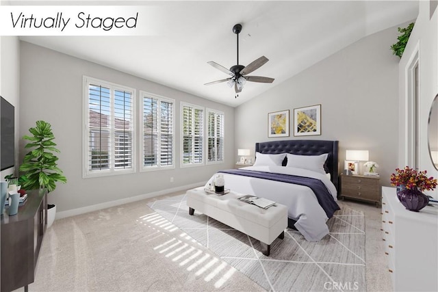 carpeted bedroom with ceiling fan and lofted ceiling