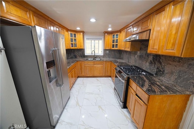 kitchen featuring dark stone counters, sink, appliances with stainless steel finishes, tasteful backsplash, and extractor fan