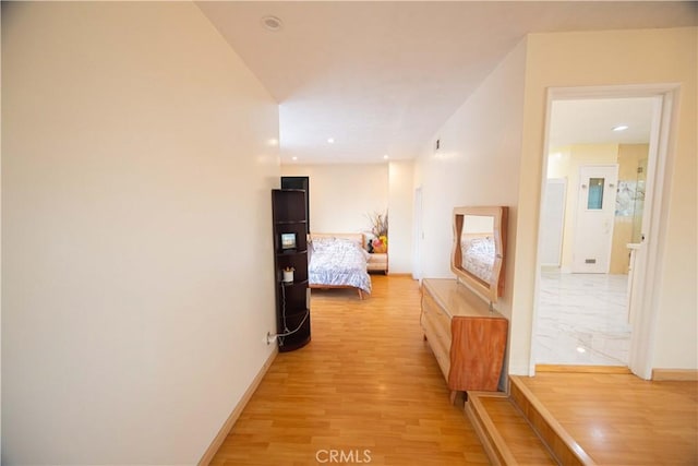 hallway with light hardwood / wood-style flooring