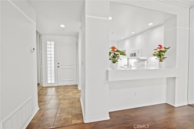 foyer entrance featuring dark hardwood / wood-style floors