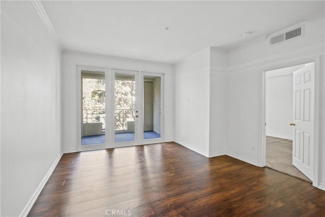 spare room with crown molding, dark wood-type flooring, and french doors