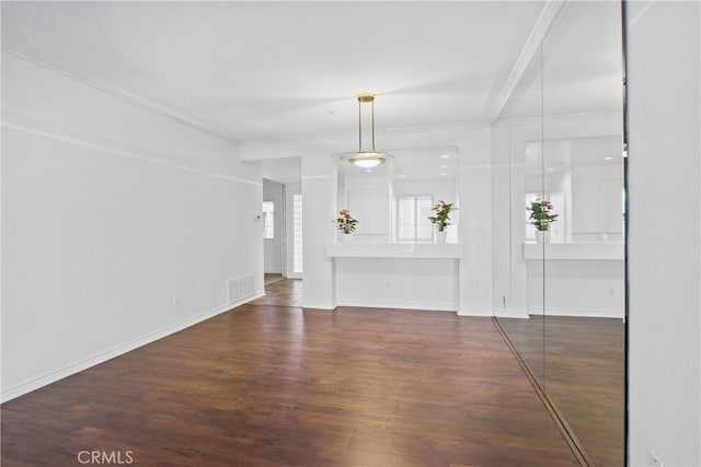 unfurnished living room with dark hardwood / wood-style flooring and crown molding