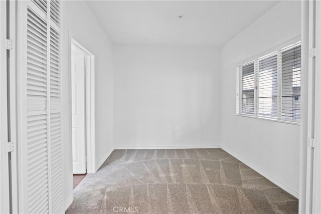 unfurnished bedroom with dark carpet