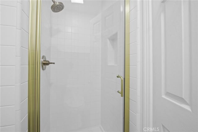 bathroom with a shower with door